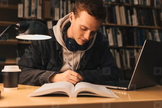 A student studying at a desk, showcasing the need for Gel Memory Foam Donut Pillows to maximize comfort and focus during long study sessions.