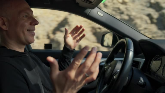 Driver in a car (road trip scene, where a donut pillow eases driving pain)