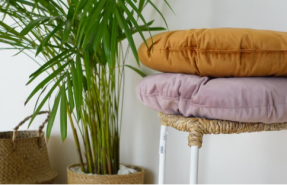 Two plush donut pillows stacked on a stool, showcasing the finished, customizable result of a DIY donut pillow project.