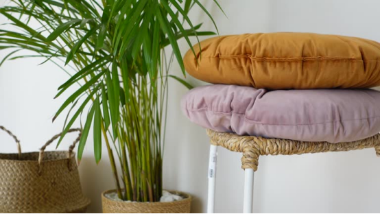 Two plush donut pillows stacked on a stool, showcasing the finished, customizable result of a DIY donut pillow project.